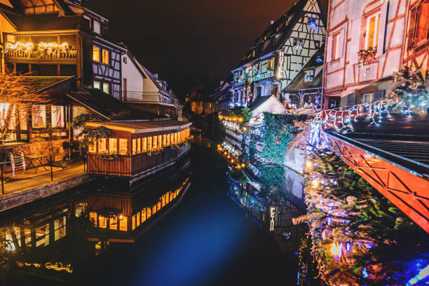 Night Life in Old Town in Colmar, Alsace, France France Water canal and traditional colored houses reflected in river Lauch at Noel time in Little Venise Colmar Haut-Rhin department Alsace France Europe decorated and illuminated at christmas time, colmar stock pictures, royalty-free photos & images