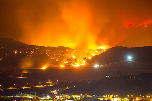 Night long exposure photograph of the Santa Clarita wildfire Night long exposure photograph of the Santa Clarita wildfire in CA. The Santa Clarita Valley mountains has drawn firefighters and emergency crews in the hills toward Acton. So far, the fire has burned 38,346 acres. california stock pictures, royalty-free photos & images