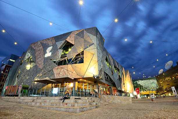 Night scene at Federation Square in Melbourne Melbourne, Australia- October 25,2015: Night scene at Federation Square in Melbourne. Federation Square, designed in 1997, with the distinctive architecture. federation square stock pictures, royalty-free photos & images