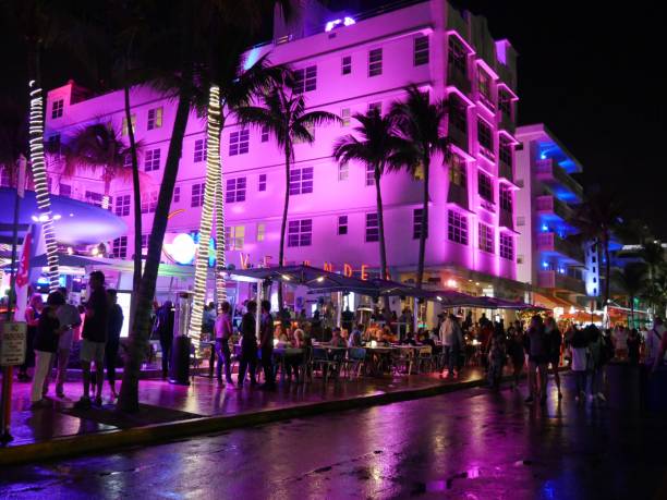 Night shot with colored lights from buildings and people walking at Ocean Drive, Miami. stock photo