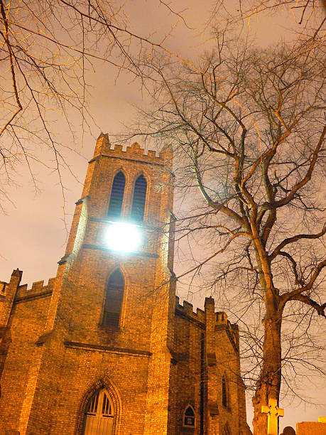 Night Time Church This picture was taken near Stourbridge with the local street lighting reflecting off the stonework,with the clock light shining through the winter night. normalisaverage stock pictures, royalty-free photos & images