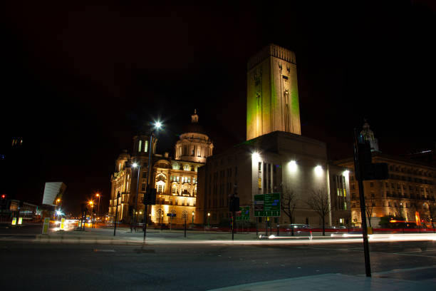 Night time image of Liverpool`s maritime mercantile heritage center historic district. Night time image of Liverpool's maritime mercantile heritage center (historic district). Image has Gerorge's Dock building in middle with Port of Liverpool building on left, Cunard building on right. liverpool docks and harbour building stock pictures, royalty-free photos & images