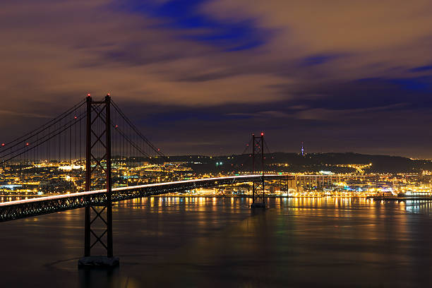 Night view of Lisbon and 25th of April Bridge stock photo