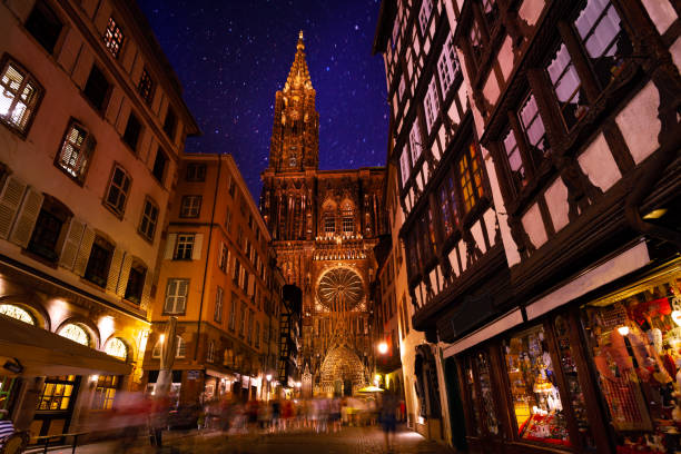 Night view of Strasbourg and Notre Dame Cathedral Beautiful view of Strasbourg streets with Notre Dame Cathedral against starry sky notre dame de strasbourg stock pictures, royalty-free photos & images