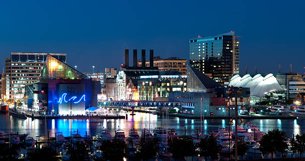 A nighttime picture of Baltimore, Maryland A view of Baltimore, Maryland&#8217;s cityscape overlooking the Inner Harbor and Patapsco River at night. inner harbor baltimore stock pictures, royalty-free photos & images
