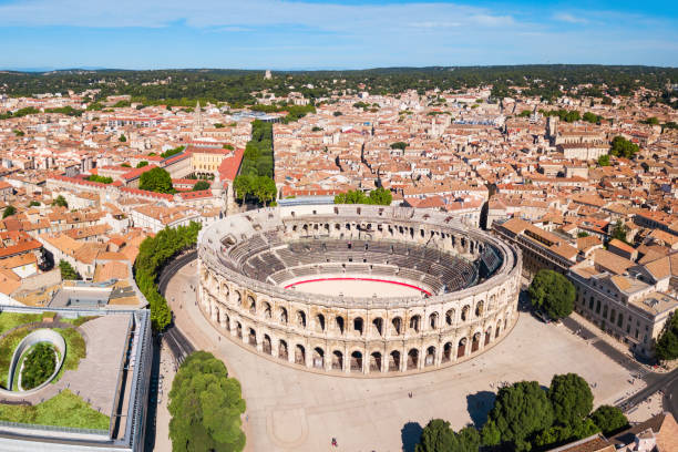 Nimes Arena aerial view, France Nimes Arena aerial panoramic view. Nimes is a city in the Occitanie region of southern France amphitheater stock pictures, royalty-free photos & images