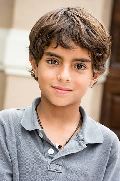 Nine years old little boy Hispanic nine years old little boy looking at the camera brown eyes stock pictures, royalty-free photos & images