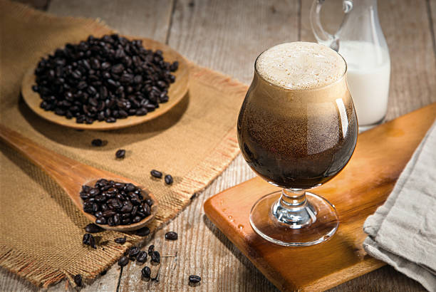 Nitro coffee nitrous infused delicious serving in tulip glass wooden stock photo