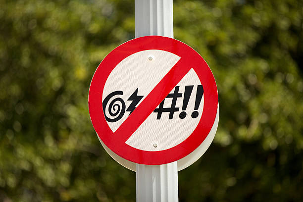 no-cursing-street-sign-in-front-of-a-green-bush-picture-id510184623