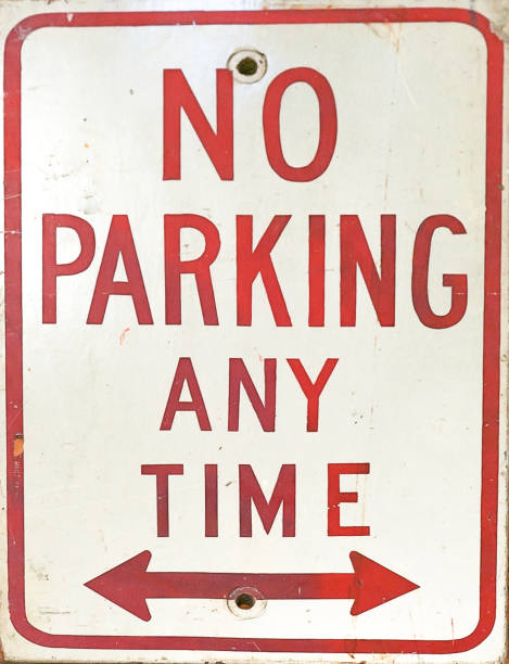 A No Parking Anytime Sign with arrows stock photo