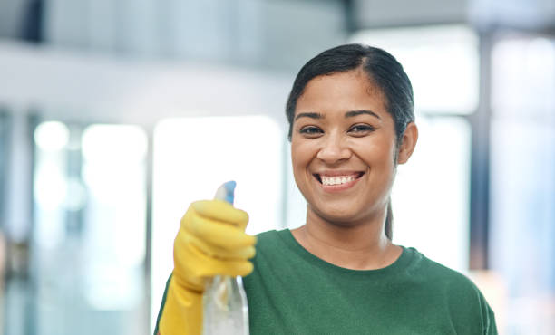 No stress, our cleaning service will handle the mess Portrait of a young woman cleaning a modern office CLEANING company stock pictures, royalty-free photos & images