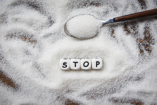 no sugar stop text blocks with white sugar on spoon wooden background picture