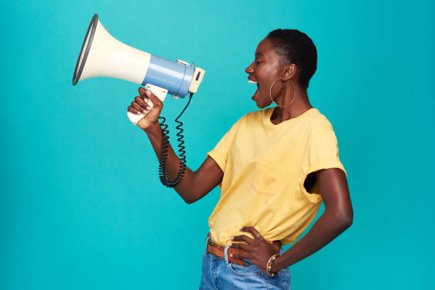 Nobody else has your voice. Use it Studio shot of a young woman using a megaphone against a turquoise background megaphone stock pictures, royalty-free photos & images