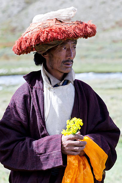 Nomad man in Dolpo, Nepal Dolpo, Nepal - September 11, 2011: Tibetan nomad with offering flowers waiting for Puja ceremony during Full Moon festival tibetan ethnicity stock pictures, royalty-free photos & images