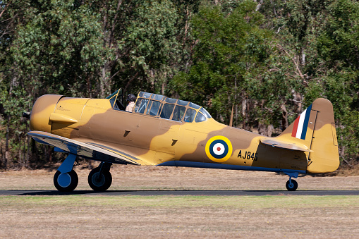 Tyabb, Australia - March 9, 2014: North American T-6 (Noorduyn AT-16) Harvard VH-TXN single engine military training aircraft from World War II taxiing at Tyabb Airport.
