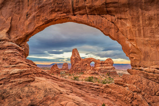 North Window and Turret Arch in Arches National Park Utah USA Stock photograph of the landmark Turret Arch as seen through North Window in Arches National Park, Utah, USA during sunrise. arches national park stock pictures, royalty-free photos & images