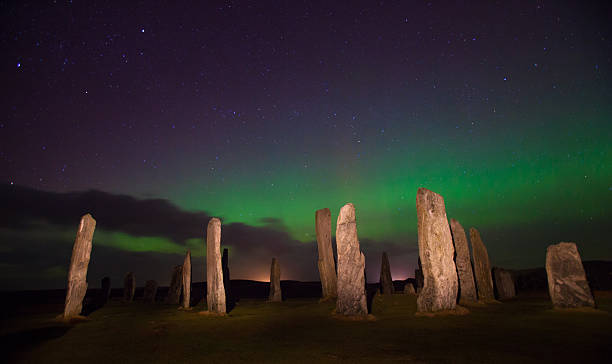 Northern Lights Callanish Stones An amazing natural phenomena, with this historic place of worship set against the backdrop of the Northern Lights in the night sky of Lewis, Outer Hebridies megalith stock pictures, royalty-free photos & images