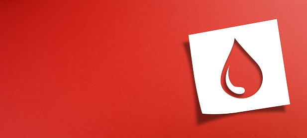 Note paper with blood donation concept on red background