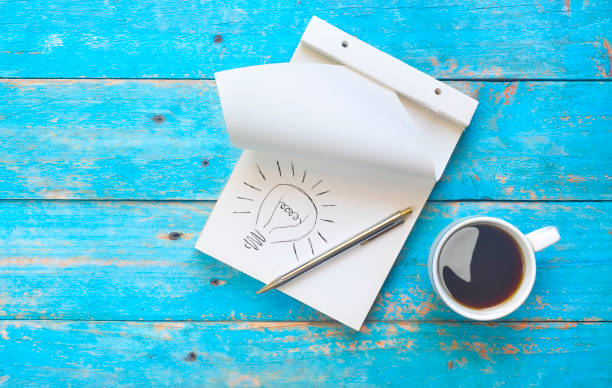 Notebook, ball pen and a cup of coffee, idea, inspiration, brainstorming concept stock photo