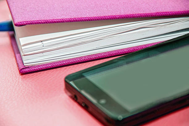 notebook, diary and mobile phone, pen and smartphone and laptop stock photo