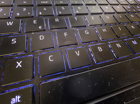 A notebook keyboard with blue light.