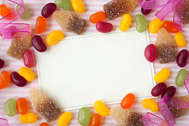 Notecard with candy. "Blank notecard with jellybeans, cola bottles, and ribbons." pick and mix stock pictures, royalty-free photos & images