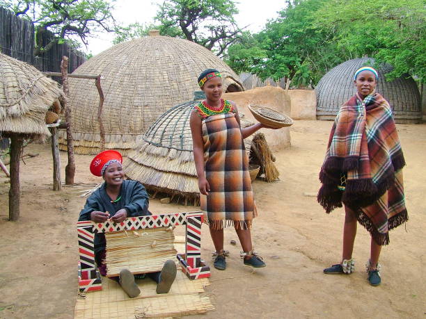 ZULULAND,  SOUTH AFRICA - CIRCA November 2011:Unidentified Zulu women in traditional Zulu clothing at Shakaland Zulu Cultural Village, KwaZulu-Natal, South Africa stock photo