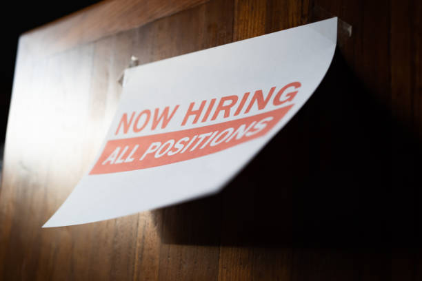 Now hiring sign on the wall stock photo