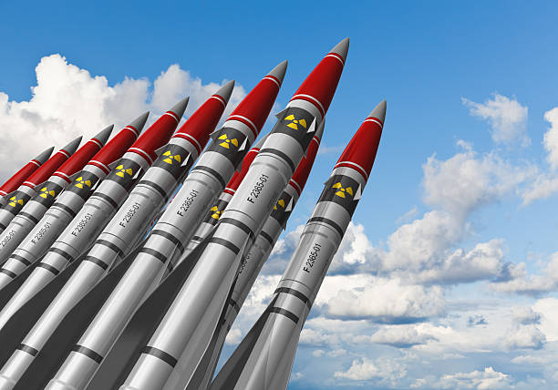 Nuclear missiles against blue sky Row of heavy nuclear missiles against blue sky with clouds. See also: radioactive contamination stock pictures, royalty-free photos & images