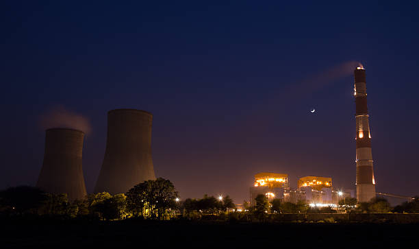 Nuclear Power Plant Illuminated Nuclear Power Plant Illuminated oil refinery factory stock pictures, royalty-free photos & images