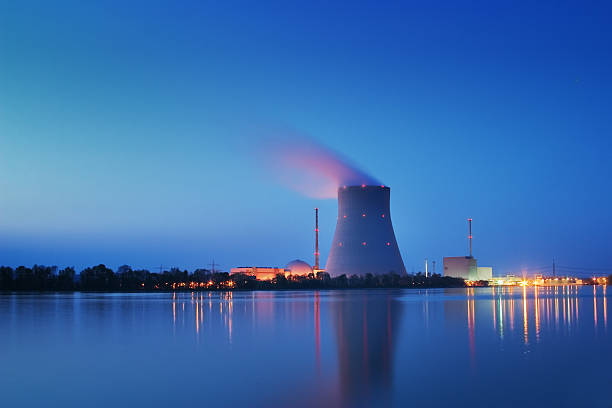 Nuclear Power Plant Long shutter time shot of a nuclear power plant at night. Image created using dri techniques. nuclear power station stock pictures, royalty-free photos & images