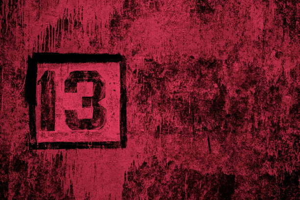 number 13 painted with black stencil on stained red concrete wall number 13 painted with black stencil on stained red concrete wall friday the 13th stock pictures, royalty-free photos & images