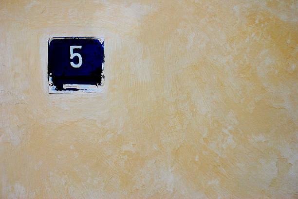 Number five on house wall stock photo