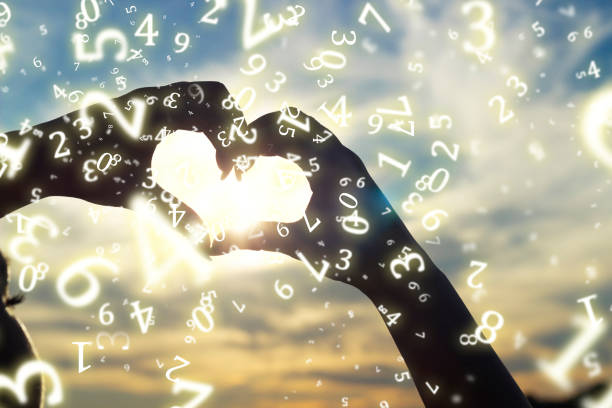 numerology, a young girl folded her hands in the shape of a heart against the background of the sun at sunset, surrounded by numbers numerology, a young girl folded her hands in the shape of a heart against the background of the sun at sunset, surrounded by numbers numerology stock pictures, royalty-free photos & images