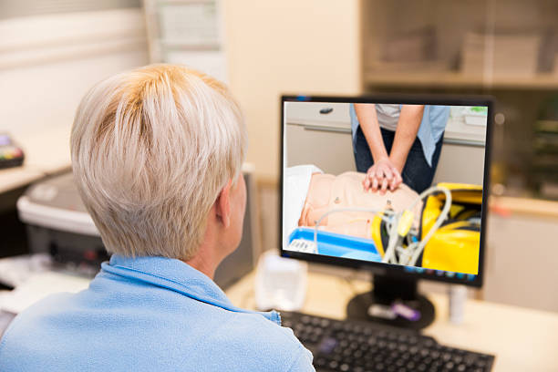 Nurse at work,watching picture of CPR training on monitor stock photo