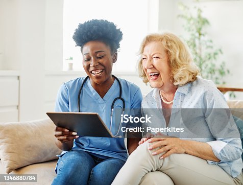 istock nurse doctor senior care tablet computer technology showing caregiver help assistence retirement home nursing elderly woman african american black happy laughing 1346880784