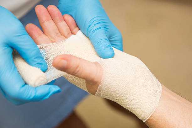 Nurse is treating patient after carpal tunnel syndrome operation stock photo