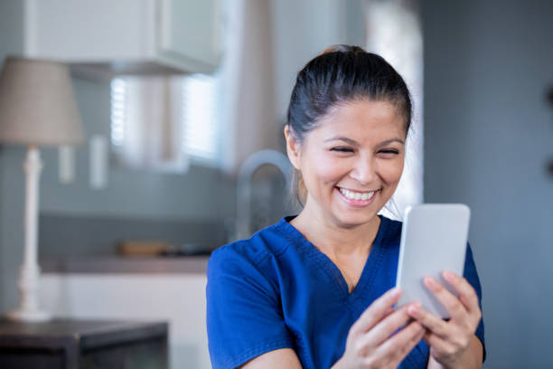 Nurse or doctor video chatting with patient during appointment while working from home Nurse or doctor video chatting with patient during appointment while working from home filipino ethnicity stock pictures, royalty-free photos & images