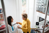 istock Nurse supporting senior patient walking or moving up the stairs at home 1322494485