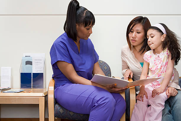 Nurse talking to mother and daughter Nurse talking to mother and daughter asian mother talking with daughter stock pictures, royalty-free photos & images