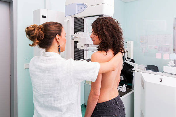 Nurse with young women having a mammography stock photo
