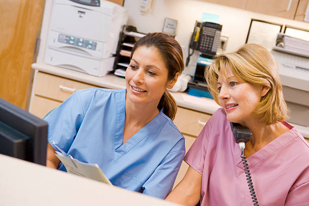 nurses at the reception area in a hospital - happy scrubs nurse phone bildbanksfoton och bilder