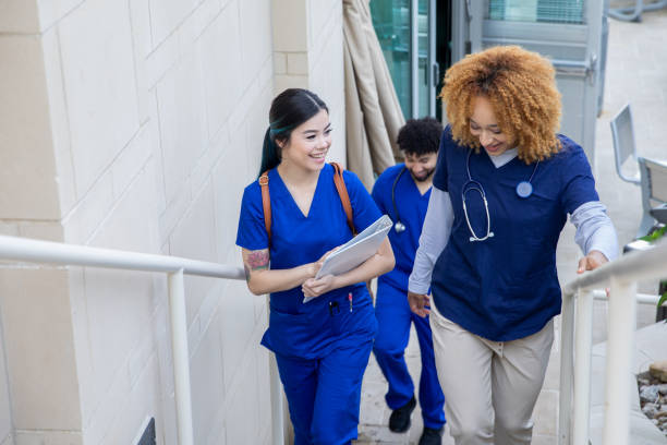 Nurses having a discussion while walking stock photo