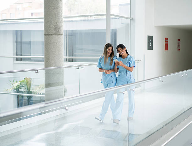nurses talking at the hospital - happy scrubs nurse phone bildbanksfoton och bilder