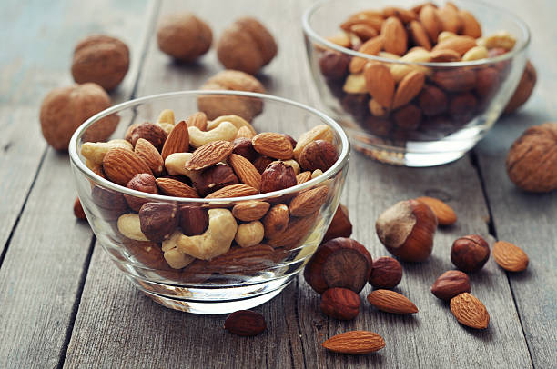 Nut mix in glass bowls stock photo
