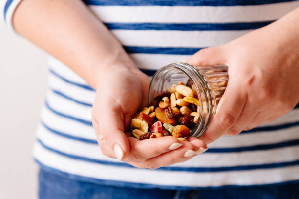 Nuts and dried fruits in hands. Cooking Hands holding a jar of nuts and dried fruits. Healthy breakfast. Sweet and healthy food, snack dried fruit stock pictures, royalty-free photos & images