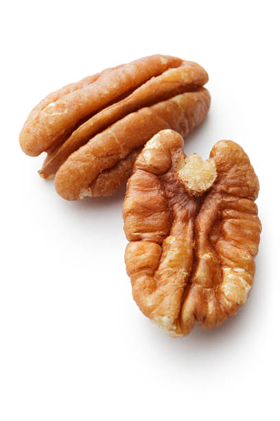 nuts: pecan nuts isolated on white background - pecannoot stockfoto's en -beelden