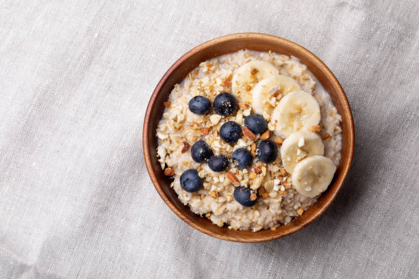 oatmeal with bananas, blueberries and almonds. oatmeal with bananas, blueberries and almonds.Vegan food. oatmeal stock pictures, royalty-free photos & images