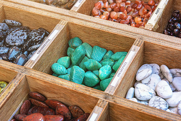 Obsidian Amazonite Agate Stones Flea Market Roussilon Wooden box with colorful volcanic stones: Obsidian, Amazonite, Agate Semiprecious Stones, Gems at the Fleamarket in the Provence Village of Rousillon, Vaucluse, Provence, France. semi precious gem stock pictures, royalty-free photos & images