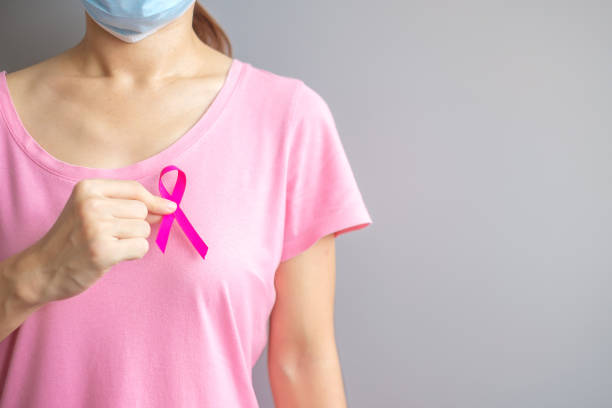 October Breast Cancer Awareness month, elderly Woman in pink T- shirt with hand holding Pink Ribbon for supporting people living and illness. International Women, Mother and World cancer day concept stock photo